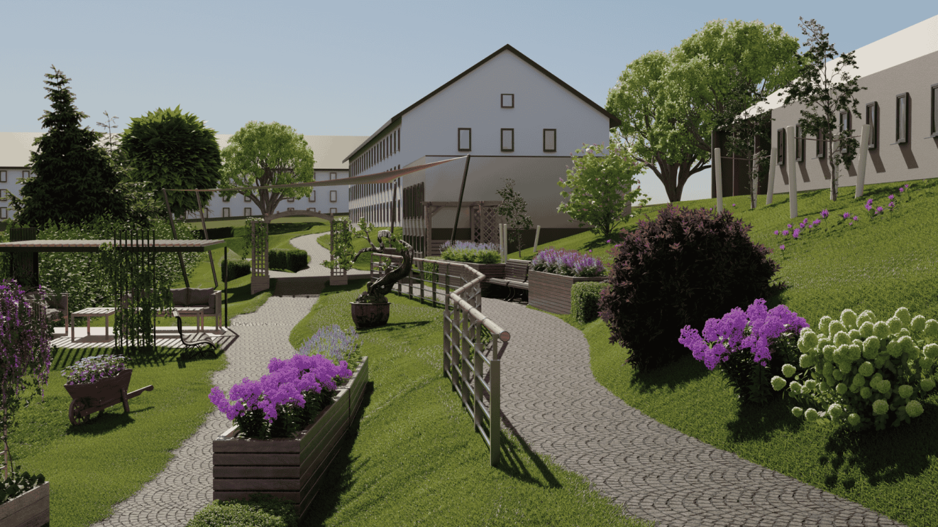 Sinnesgarten - Friedenshort Landschaft mit gepflastertem Weg, Bäumen, Blumenbeeten und einem Gebäude im Hintergrund.